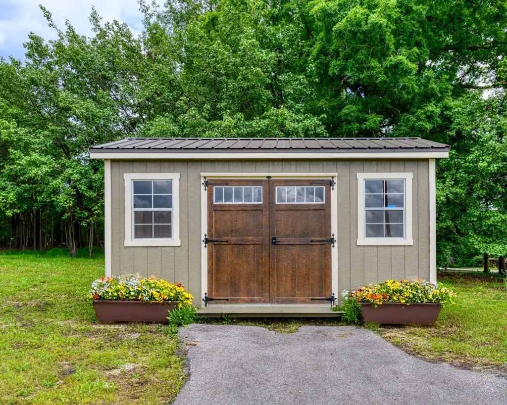 Painted cabin with double barn door and two windows