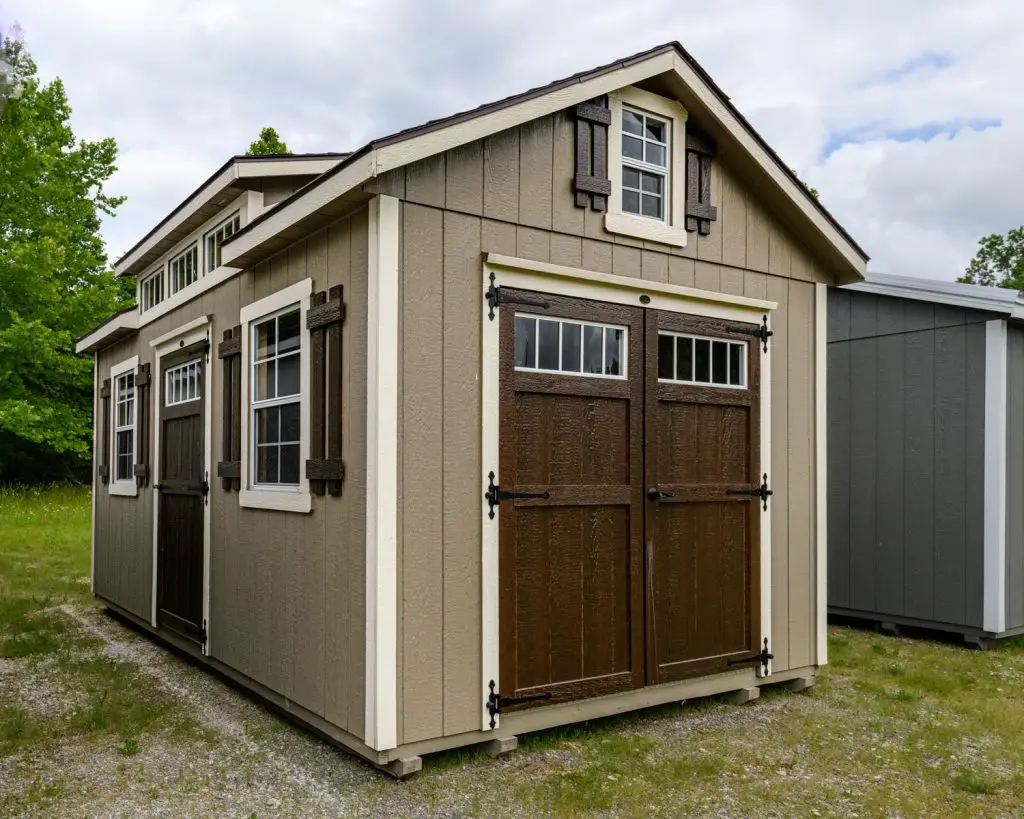 Painted carriage house with dormer and double barn doors.