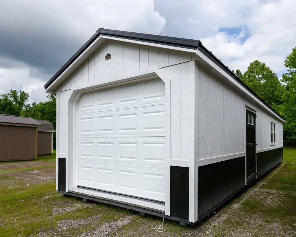 White painted carriage house garage style portable storage building